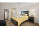 Cozy bedroom featuring a yellow comforter, neutral walls and carpet, as well as a decorative mirror at 1251 Saranac Pl, The Villages, FL 32163