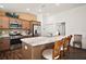 Modern kitchen with stainless steel appliances, a spacious island, and three bar stools at 1251 Saranac Pl, The Villages, FL 32163