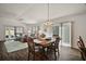 Spacious living and dining area featuring wood floors and sliding doors leading to the patio at 1251 Saranac Pl, The Villages, FL 32163
