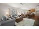 Spacious living room with comfortable seating, natural light, and seamless flow to dining and kitchen areas at 1251 Saranac Pl, The Villages, FL 32163