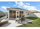 Cozy outdoor patio with screened-in porch and fire pit, perfect for entertaining and relaxation at 1251 Saranac Pl, The Villages, FL 32163