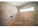 Modern walk-in shower with neutral tile, a window, and sleek fixtures at 1251 Saranac Pl, The Villages, FL 32163