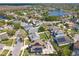 A distant aerial view of a neighborhood featuring a large lake and many two-story homes at 13519 Bristlecone Cir, Orlando, FL 32828