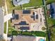 An overhead view of a home showcasing its solar panels, landscaping, and brick-paved outdoor spaces at 13519 Bristlecone Cir, Orlando, FL 32828