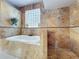 Bright bathroom featuring a soaking tub and shower with tile surround at 13519 Bristlecone Cir, Orlando, FL 32828