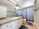 Bathroom featuring a large mirror, shower with a curtain, and a single sink at 13519 Bristlecone Cir, Orlando, FL 32828