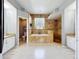 Bathroom with a garden tub, walk-in shower, tile flooring, and dual vanities at 13519 Bristlecone Cir, Orlando, FL 32828