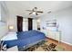 Bedroom with a ceiling fan, private balcony, and a white dresser; neutral color pallet at 13519 Bristlecone Cir, Orlando, FL 32828