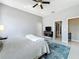 Bedroom featuring a ceiling fan, closet, dresser, and hardwood flooring at 13519 Bristlecone Cir, Orlando, FL 32828