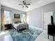Bedroom with two large windows, a ceiling fan, hardwood floors, and blue patterned rug at 13519 Bristlecone Cir, Orlando, FL 32828