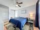 Bedroom with ceiling fan, closet, side table, and hardwood flooring at 13519 Bristlecone Cir, Orlando, FL 32828