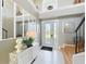 Bright foyer with white tile flooring, staircase, and stylish decor at 13519 Bristlecone Cir, Orlando, FL 32828