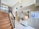 Sun-filled foyer with staircase leading to the second floor and decorative details for an elevated style at 13519 Bristlecone Cir, Orlando, FL 32828