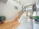 Sun-filled foyer with staircase leading to the second floor and entry to the formal living area at 13519 Bristlecone Cir, Orlando, FL 32828