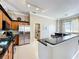 Open kitchen includes stainless steel appliances, granite counters and breakfast bar to enjoy a snack at 13519 Bristlecone Cir, Orlando, FL 32828