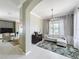 Cozy living room with large windows, a ceiling fan, and stylish decor at 13519 Bristlecone Cir, Orlando, FL 32828