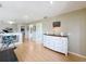 Bright living room with light wood floors, white dresser, and exercise equipment at 13519 Bristlecone Cir, Orlando, FL 32828