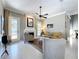 Inviting living room featuring a fireplace, neutral walls, a ceiling fan, and sliding glass door to the backyard at 13519 Bristlecone Cir, Orlando, FL 32828