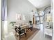 Bright living room with soaring ceilings, comfortable seating, and views of the foyer at 13519 Bristlecone Cir, Orlando, FL 32828