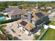 An aerial view of the back of a two-story home with solar panels and a brick patio at 13519 Bristlecone Cir, Orlando, FL 32828