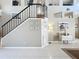 Open staircase featuring black railings, tile floors, and decorative wall art at 13519 Bristlecone Cir, Orlando, FL 32828