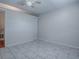 Bedroom with neutral walls, gray tile and closet at 1400 Eudora Rd # A08, Mount Dora, FL 32757