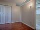 Bedroom with wood floors, double closet, and wall sconce at 1400 Eudora Rd # A08, Mount Dora, FL 32757