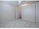 Bedroom with neutral walls, gray tile, closet and ceiling fan at 1400 Eudora Rd # A08, Mount Dora, FL 32757