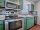 Updated kitchen with stainless steel appliances and mosaic backsplash at 1400 Eudora Rd # A08, Mount Dora, FL 32757