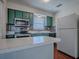 Galley style kitchen featuring tiled backsplash, stainless appliances, and ample counter space at 1400 Eudora Rd # A08, Mount Dora, FL 32757