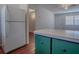 Open kitchen area featuring white refrigerator, and bar counter area at 1400 Eudora Rd # A08, Mount Dora, FL 32757