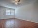 View of the living room with window and neutral walls and a ceiling fan at 1400 Eudora Rd # A08, Mount Dora, FL 32757