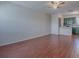 Open-concept living room and kitchen with wood-look tile floors and a ceiling fan at 1400 Eudora Rd # A08, Mount Dora, FL 32757