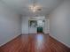 Spacious living room with wood-look tile floors open to the kitchen area at 1400 Eudora Rd # A08, Mount Dora, FL 32757