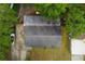 Birds eye view of the house featuring the roof and surrounding greenery, with driveway and street visible at 1406 Spartan Ave, Leesburg, FL 34748