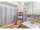 Retro bathroom featuring a pink toilet, sink, and a shower-tub combo at 1406 Spartan Ave, Leesburg, FL 34748