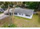 Charming single story home with carport and white exterior and blue shutters at 1406 Spartan Ave, Leesburg, FL 34748