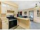 Cozy kitchen features retro cabinets and stainless steel oven range at 1406 Spartan Ave, Leesburg, FL 34748