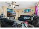 Comfortable living room with black leather recliners and large screen television at 1406 Spartan Ave, Leesburg, FL 34748