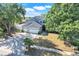 Charming two-story home featuring a three-car garage, arched entry and lush, mature landscaping at 14305 Pine Cone Trl, Clermont, FL 34711