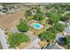 Aerial view of a community pool surrounded by lush trees and a parking lot at 14305 Pine Cone Trl, Clermont, FL 34711
