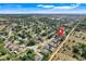 Aerial view of a neighborhood with lush greenery and residential homes at 14305 Pine Cone Trl, Clermont, FL 34711