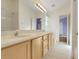 Bright bathroom featuring double sinks, tile floors, and a tub-shower combination at 14305 Pine Cone Trl, Clermont, FL 34711