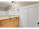 Bathroom with wooden vanity, stylish mirrors, and wainscotting on the walls at 14305 Pine Cone Trl, Clermont, FL 34711