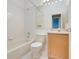 Full bathroom featuring a bathtub with shower, toilet and wooden vanity at 14305 Pine Cone Trl, Clermont, FL 34711