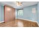 Bedroom features a Murphy bed, wood-look floors, and a ceiling fan light fixture at 14305 Pine Cone Trl, Clermont, FL 34711