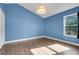 Bedroom with wood-look floors, fresh paint, natural light, and a ceiling light fixture at 14305 Pine Cone Trl, Clermont, FL 34711
