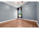 This spacious bedroom features hardwood floors, fresh paint, and natural light at 14305 Pine Cone Trl, Clermont, FL 34711