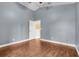 Bright bedroom features hardwood floors, fresh paint, and ample closet space at 14305 Pine Cone Trl, Clermont, FL 34711