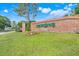 Community entrance sign for Greater Pines with landscaped lawn and flower beds at 14305 Pine Cone Trl, Clermont, FL 34711